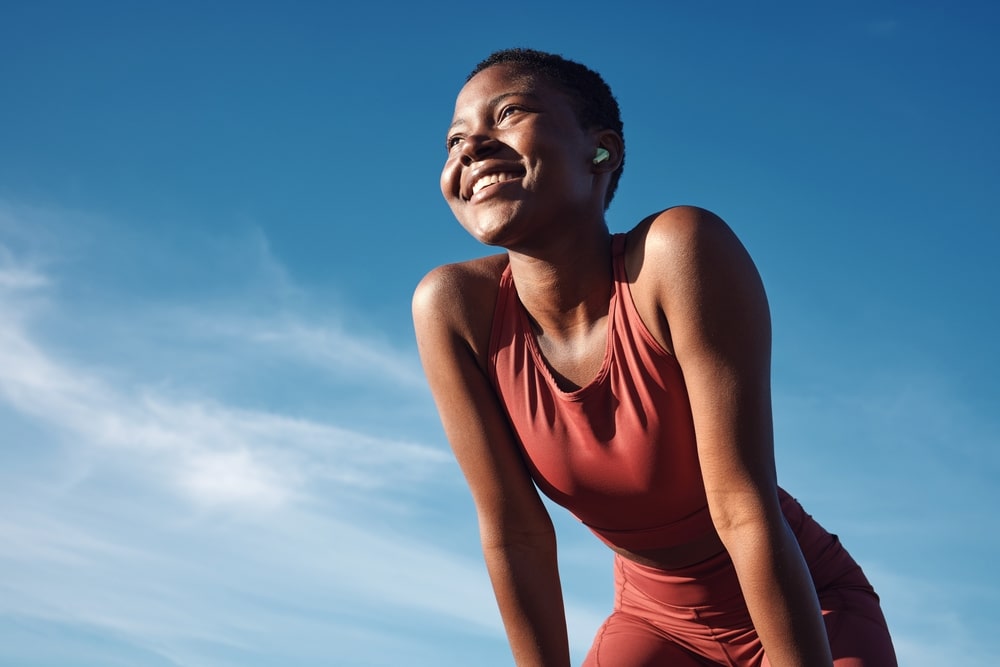 woman runner breathing with happiness from sport outdoor