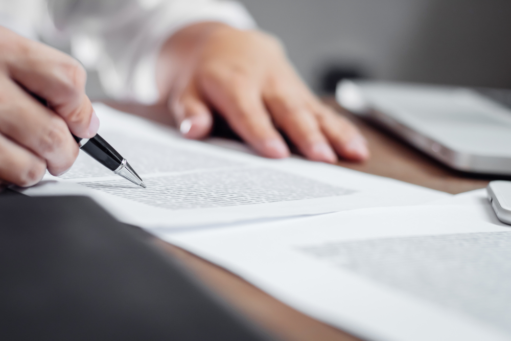 Patient reviewing medical insurance coverage documents at a Premier Spine & Orthopaedics clinic in New Jersey